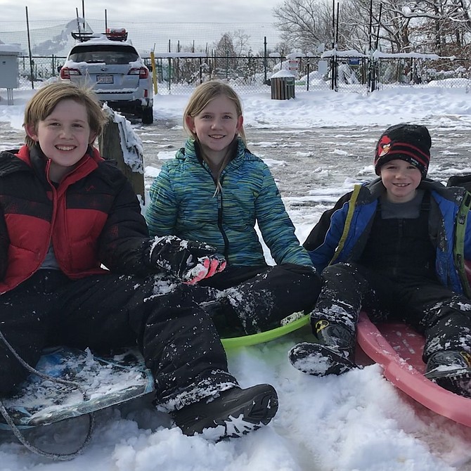 The Bass children of Reston, Billy, 12, Taylor, 9, and Dylan, 6, prepare to conquer the beast of all sledding hills in the area, "Mount Reston," located at the end of the parking lot behind the Unitarian Universalist Church, 1625 Wiehle Avenue.