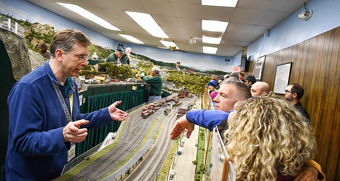 Jim Mullison, of Lorton, chats with visitors in the model railroad room.