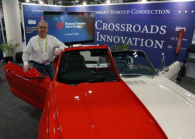 Vince Grecznaik, of the National Inventors Hall of Fame Museum in Alexandria, stands next to the museum’s custom Ford Mustang Jan. 11 at the CES 2019 technology show in Las Vegas. The vehicle – a split-model car that merges a 1965 and 2015 model Mustang - demonstrates the progress of automotive design and technology over the course of 50 years. It is scheduled to return to its normal exhibit location inside the museum later this week.