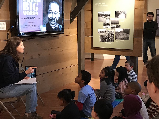 An instructor reads Doreen Rappaport’s picture-book biography, "Martin’s Big Words: The Life of Dr. Martin Luther King Jr.," during the Martin Luther King Jr. Day of Service at Frying Pan Farm Park in Herndon.