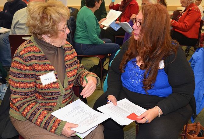 Jackie Wilson of McLean and Joanie Young of Oakton practice some of the listening and speaking skills offered at the Better Angels workshop on “Talking Across the Political Divide” held at the Patrick Henry Public Library in Vienna. “This is a good start,” said Wilson. “We need to find the common things that hold us together.”