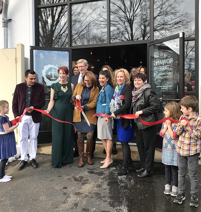 Lisa C. Merkel, Mayor of Herndon, cuts the ribbon during the Grand Opening of Rowan Tree, Tuesday, Jan. 15, 2019, as co-founders Amy Dagliano (left) and Kate Viggiano Janich (right) look on. Herndon Town Councilmembers Pradip Dhakal (far left) and Vice Mayor Sheila Olem and Signe Friedrichs (right) help as Fairfax County Supervisor John Foust (D-Dranesville) looks on.