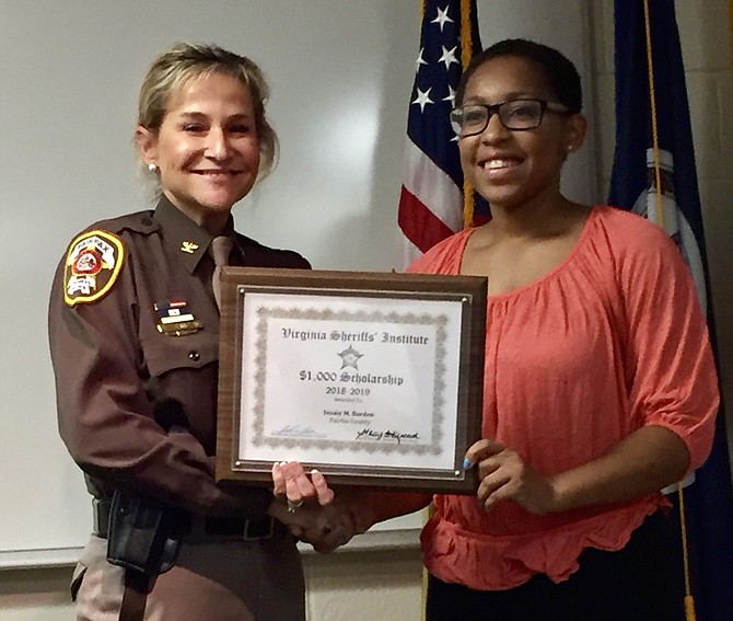 Fairfax County Sheriff Stacey A. Kincaid presents a 2018-2019 Virginia Sheriffs’ Institute College Scholarship to Sesaly Barden, a graduate of South Lakes High School in Reston. Scholarship applications for 2019-2020 are available Jan. 31, 2019.
