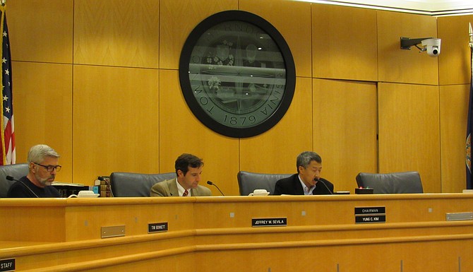 Three of the five Town appointed members of the Herndon Board of Zoning Appeals review their notes.