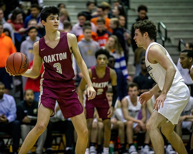 Garrett Johnson #3 looks to pass the ball to a teammate as Gavin Kiley #5 defends.