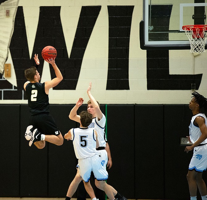 Taylor Morin (2) goes vertical to elevate over two Centreville defenders.