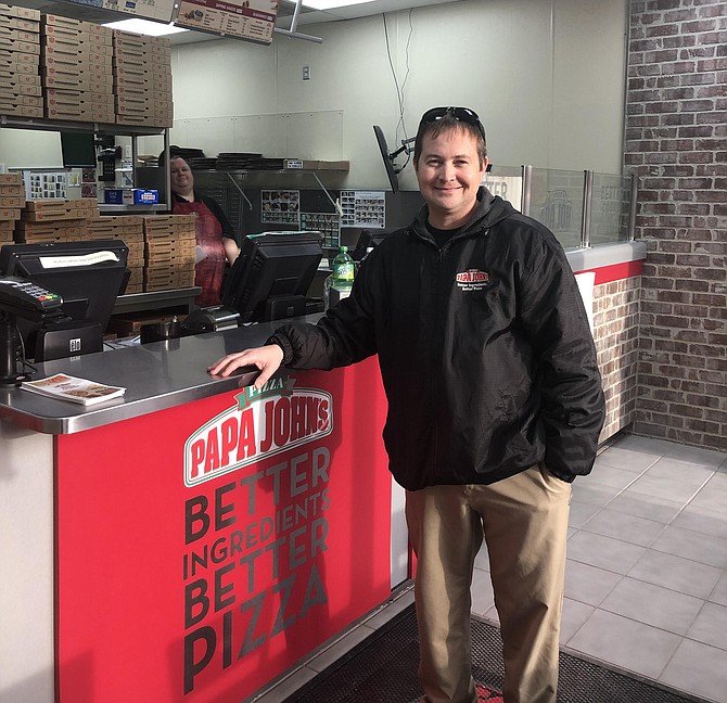 Justin Hamacher inside his Papa John’s store.