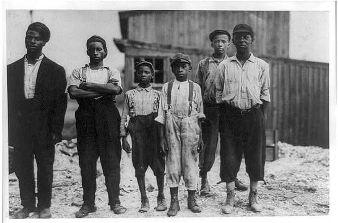 “The Negro Work Force of the Alexandria Glass Factory.” The picture was taken in 1911.