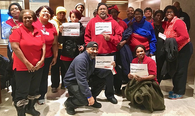 Public school custodians gave public testimony and held up "Don't privatize our jobs!" signs at last week's School Board meeting.