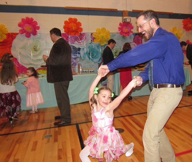 Morgan Franklin of Herndon puts the spotlight on his special girl, daughter Aubree, 6,  spinning her round and round across the floor during the town of Herndon’s Father Daughter Dance held at the Community Center Feb. 2, 2019.