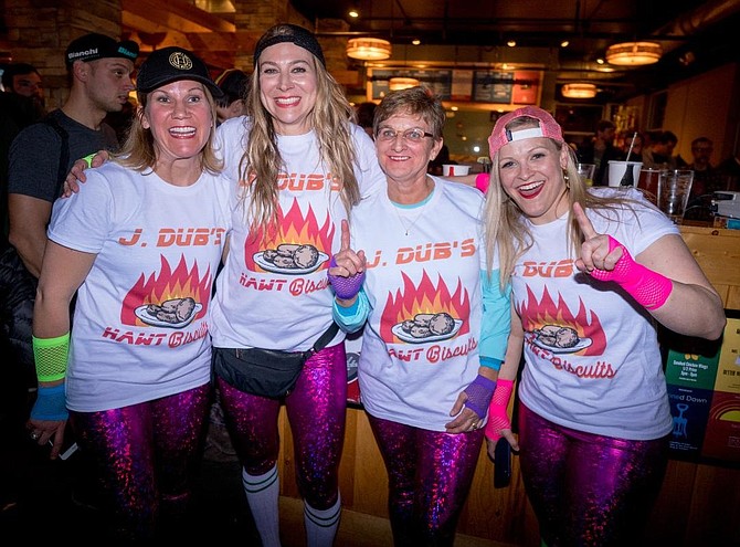 Del Ray Realtor Jen Walker, second from right, and her teammates pose for a photo after competing in the 500-meter indoor cycling sprints Feb. 4 at Pork Barrel BBQ. The event was part of a fundraiser to support VeloCity Bicycle Cooperative co-founder Christian Myers, who is battling cancer.