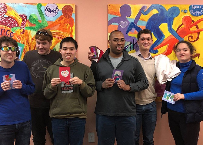 (Second from right) Kevin Barbera, Founder and CEO Barbera Foundation, joins (from left) Ryan McMahon and Ian Nordling of Herndon and Huan Vuong, Ben McGann and Emma Budway of Arlington as they hold a sampling of the 250 handcrafted Valentine’s Day cards with personalized greetings they created.