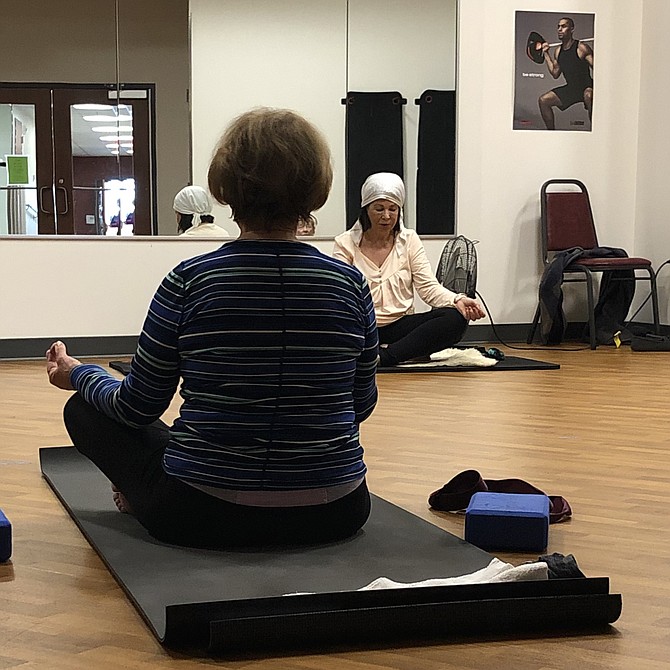 Dr. Christine Mason leads her class in meditation chants.