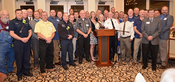 The “career” personnel, present and past, gather to wish a fond farewell to their retiring volunteer partner, Homer Johns, at the party in his honor.
