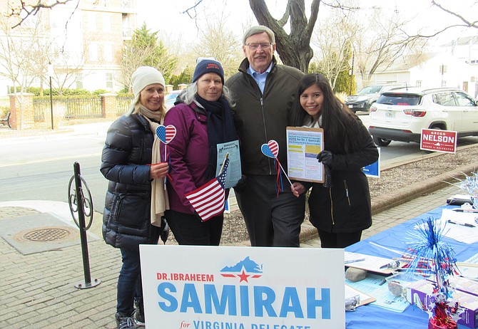 Kat Kehoe of McLean, Kris Gregory of McLean, Fairfax County Board of Supervisors-Dranesville, John Foust (D) and Christy Villalobos of Herndon man the polling station table for Dr. Ibraheem Samirah during absentee voting at the Herndon Fortnightly Library on Saturday, Feb. 16, 2019.