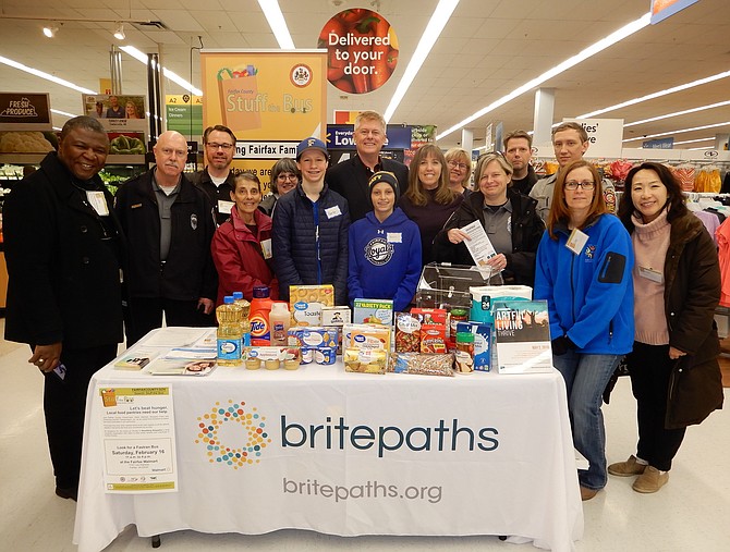 Volunteers from several entities participated in the Stuff the Bus food drive for Britepaths’ food pantry. In the center (back row) is Braddock District Supervisor John Cook.