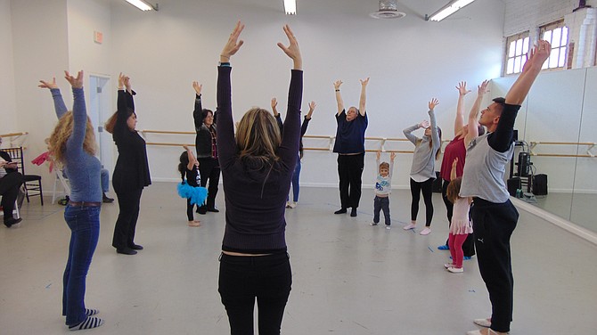 Modern dance instructor Roxann Morgan Rowley leads stretching in the NRDC Company Class during the Open House at Workhouse Arts Center.