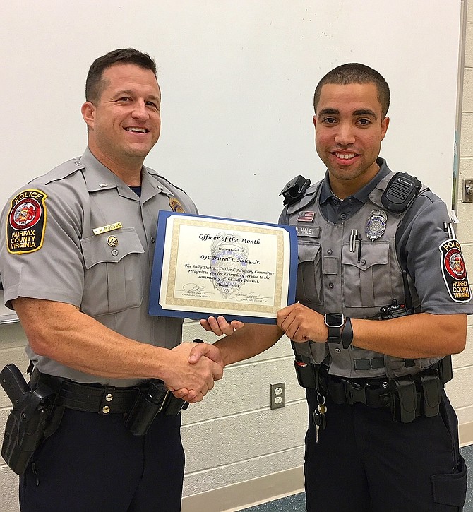 Lt. Ryan Morgan (left) presents the award to PFC Darrell Haley Jr.