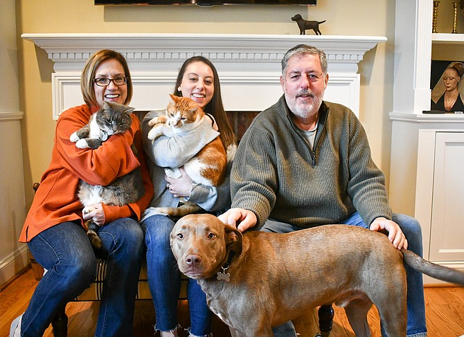 Jane, Hannah, 23, and Bob Picardi sit with their family of pets: Cats Bernie, Nacho, and their dog Cooper.