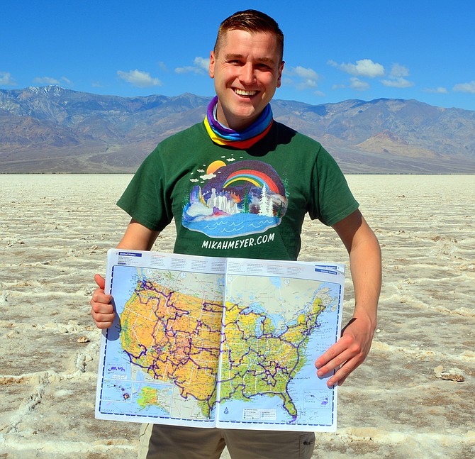 Former Bethesda resident Mikah Meyer is visiting all 418 U.S. National Parks and Historic Sites in one continuous trip. In Death Valley National Park, Calif., he shows a map charting progress of his trip.