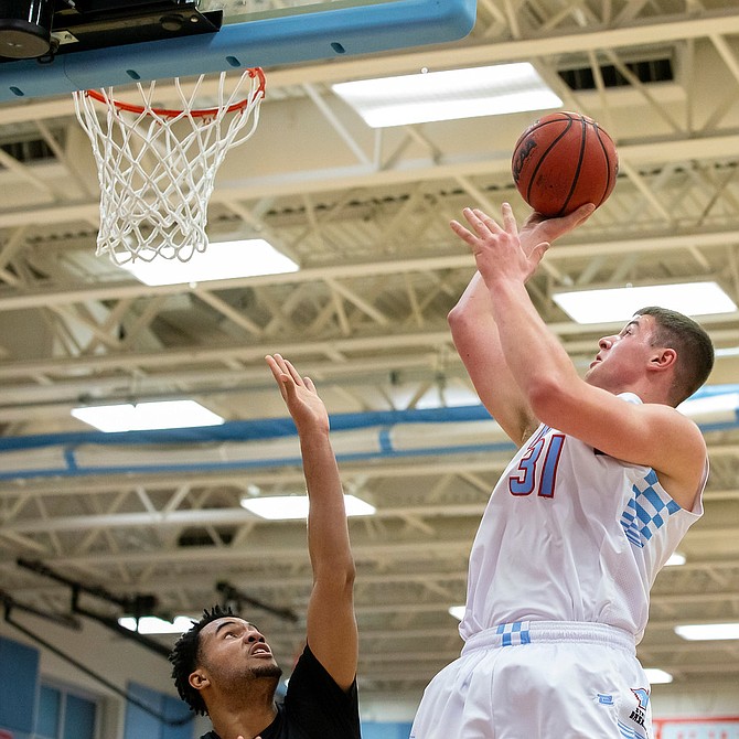 Marshall’s Daniel Deaver #31 elevates over Marshall Reed of Westfield.