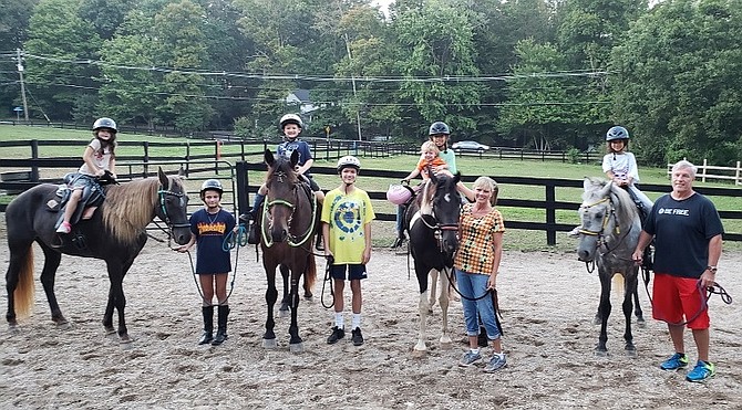 From left: Brooklyn on Cocoa, Christina, Hunter on Morgan, Christian, Gabriella and Henry on Ruger, Tina Maier, Allysa on Traveller, and Chris Maier at Live, Laugh, Relax Therapeutic Center in Fairfax Station.