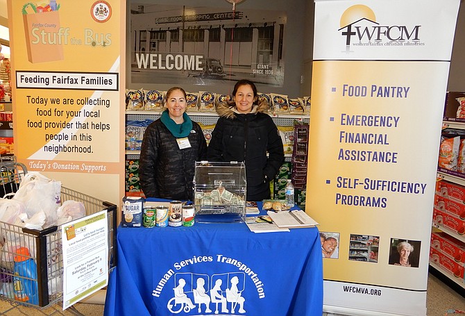 Manning WFCM’s donation table inside the Colonnade Giant are (from left) Yesica Agents of Fairfax County’s Neighborhood and Community Services and WFCM’s Pamela Montesinos.