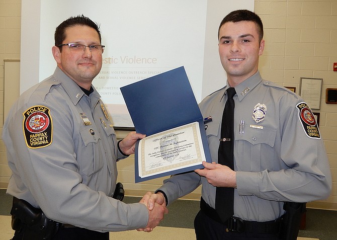 Assistant Station Commander, Lt. Todd Billeb (left), presents the Officer of the Quarter award to Officer Thomas Rubinstein.