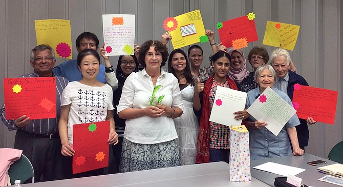 English as a Second Language (ESL) students and a volunteer hold a retirement party for Ivanka Atanasova, Library Information Assistant at Reston Regional Library. Atanasova coordinated the ESL Program.