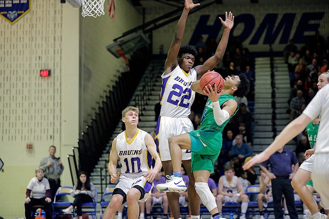 South Lakes’ Brian Adams #1 is blocked by Lake Braddock’s David Solomon #22.