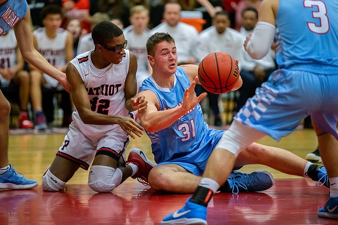 Marshall’s Daniel Deaver #31 scoops up a loose ball and tosses it to teammate Alex Hakim #3.