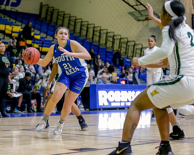 Olivia Nielsen #21 drives to the basket for South Lakes.