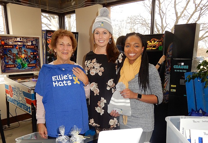 Volunteer Fairfax members (from left) Barbara Small, Michelle Jacobs and Katrice Saddler man the Ellie’s Hats fundraising table selling hats and T-shirts.