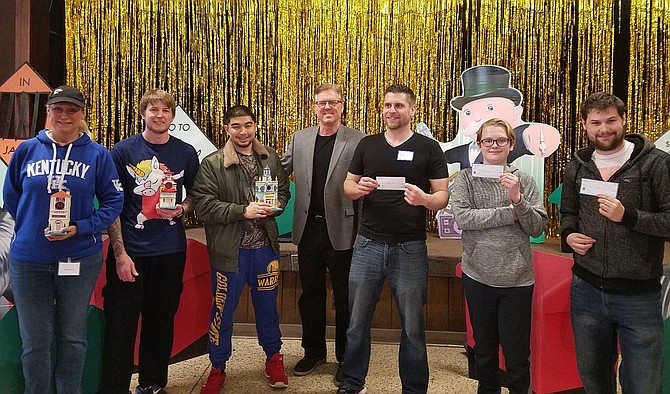 The Monopoly Tournament winners with Organizer Ron Kowalski (center). Winning first place (from left to right) was Bobby Driscoll, who won $500; second place went to Alex Kowalski, who won $250; third place went to David Adkins, who won $100; fourth place went to Melson Varsovia; fifth place went to Carl Klein; and sixth place went to Robin Nicholas.