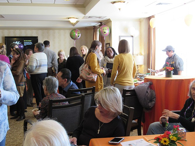 Residents of Sunrise at Reston Town Center and Sunrise at Countryside mingle during the Iron Chef-style Cook-off Competition featuring Mardi Gras Party food.