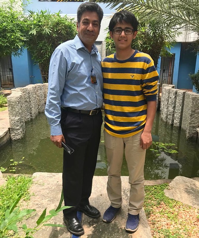 Avyuk Dixit with Dr. Rengaraj Venkatesh, chief medical officer at Aravind Eye Hospital in Pondicherry, India.