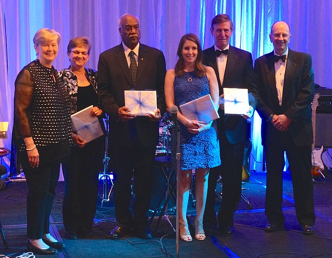 Senior Services of Alexandria executive director Mary Lee Anderson, left, and board chair Jack Fannon, right, are joined onstage by honorees Jen Walker, Lynnwood Campbell, Stephanie Beyer Kirby and U.S. Rep. Don Beyer (D-8) at the Senior Services of Alexandria Gala March 16 at the Westin Alexandria.