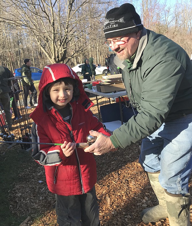 Bradley Wang, 6, of Reston, shivers in the cold, but is prepared to catch his first Rainbow Trout during Reston Association's annual Kids’ Trout Fishing Day 2019.