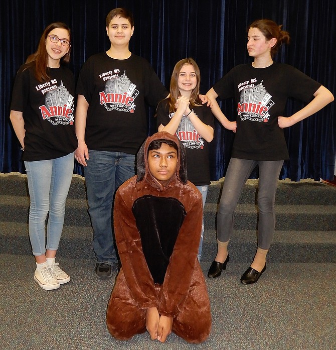 Starring in Liberty Middle’s production of “Annie Jr.” are (standing, from left) Beth Buono, Noah Martineau, Caitlyn Barnes and Maddie LeBerre, with Samin Haque as Sandy the dog.