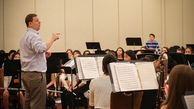 Looking up and listening to their band director, Matthew Baker, Cooper students get ready to play their instruments. Students admired Baker’s dedication to making them the best they could be.