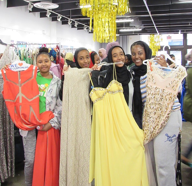 Marafi Osman, 12, Rzaz and Rzan Ali, 15, and Raghad Salih, 16, local middle and high school students, consider formal wear for prom and spring dance at the 17th annual Diva Central event presented by Reston Community Center at Lake Anne.