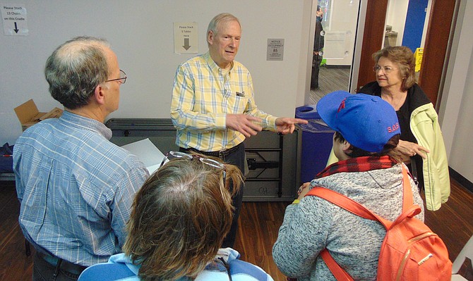 John Browne greets guests from the Burke Historical Society after his lecture.