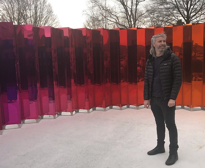 Artist Michael Szivos stands inside Mirror Mirror, the inaugural public art installation at Waterfront Park, during the March 29 media tour.