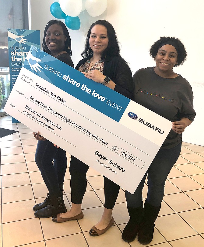 Teresa Ross, Lisbeth Delcid and Colida Johnson celebrate the donation of more than $24,000 to Together We Bake from Alexandria’s Beyer Subaru. The trio are graduates of the nonprofit’s job training program and are now employees of the organization.