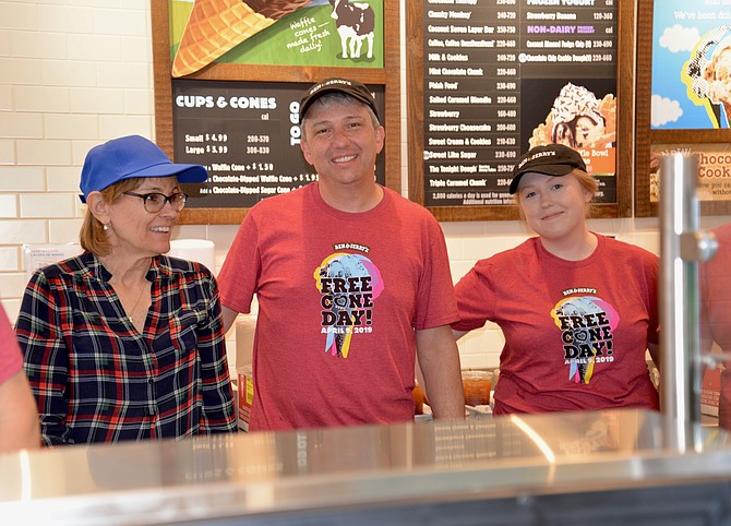 The Vienna Ben & Jerry’s owner Kyle Hosch had lots of willing assistants on Free Cone Day, like Carol Hamal (left), a volunteer with local nonprofit Committee for Helping Others (CHO). CHO was the designated charitable organization that Hosch called the “perfect partner” to benefit from donations made during the event. On the right is scooper extraordinaire and B & J’s employee Moira Harris.