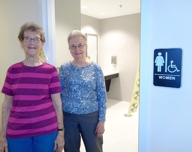 Culpepper Garden staff member Candy Dragity and resident Janice Nichols take the tour of the newly renovated restrooms at Culpepper Garden on April 12.