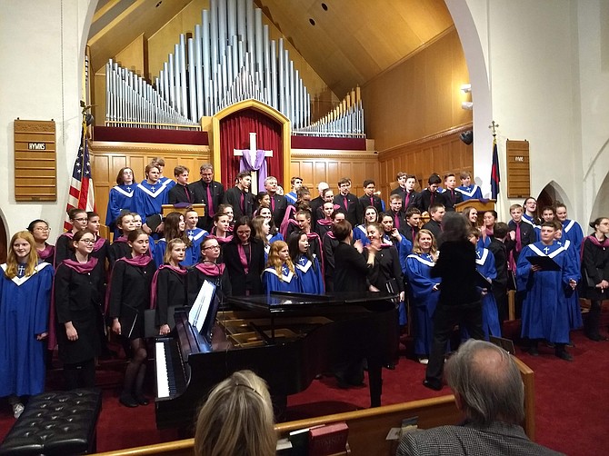 The Maitrise de Reims, choristers dressed in black, sang with the Clarendon United Methodist Church choir, dressed in blue.