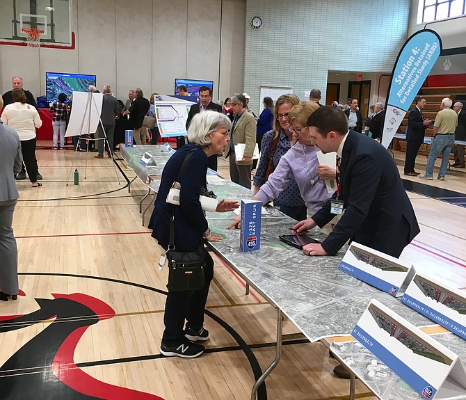 Scores of people attending the workshop on proposals to widen the Beltway and I-270 spread out at different exhibits around the cafeteria of Pyle Middle School in Bethesda.