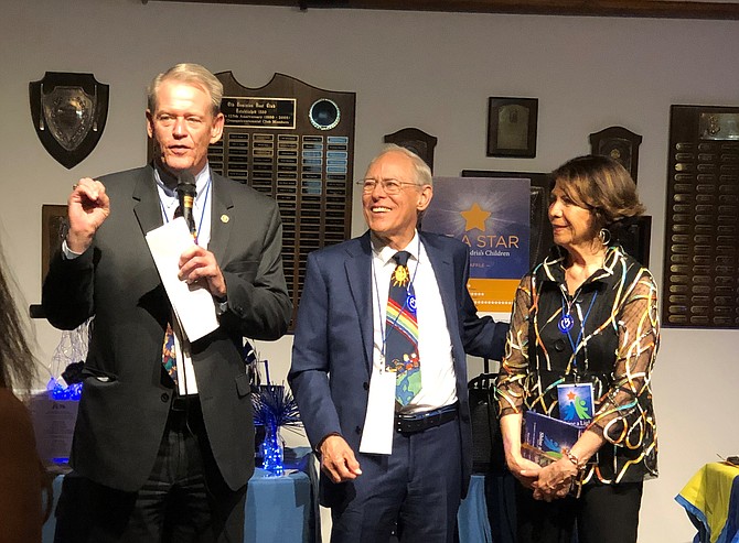 The Center for Alexandria’s Children board chair Kerry Donley, left, honors Tom and Magaly Hirst with the Champion of Children Award at the 10th annual CAC Gala April 4 at the Old Dominion Boat Club.