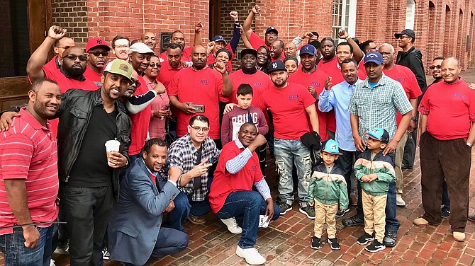 DASH bus drivers, sporting Amalgamated Transit Union Local 689 t-shirts, outside city hall after petitioning city council to help raise their pay at a public hearing on Saturday, April 13.